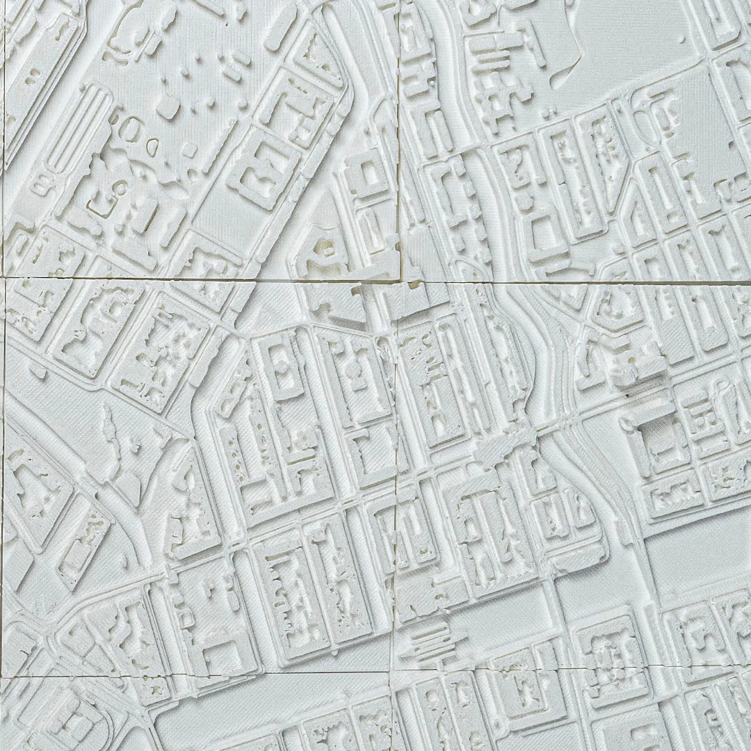 Close view of raised buildings and narrow streets in an Amsterdam relief map.