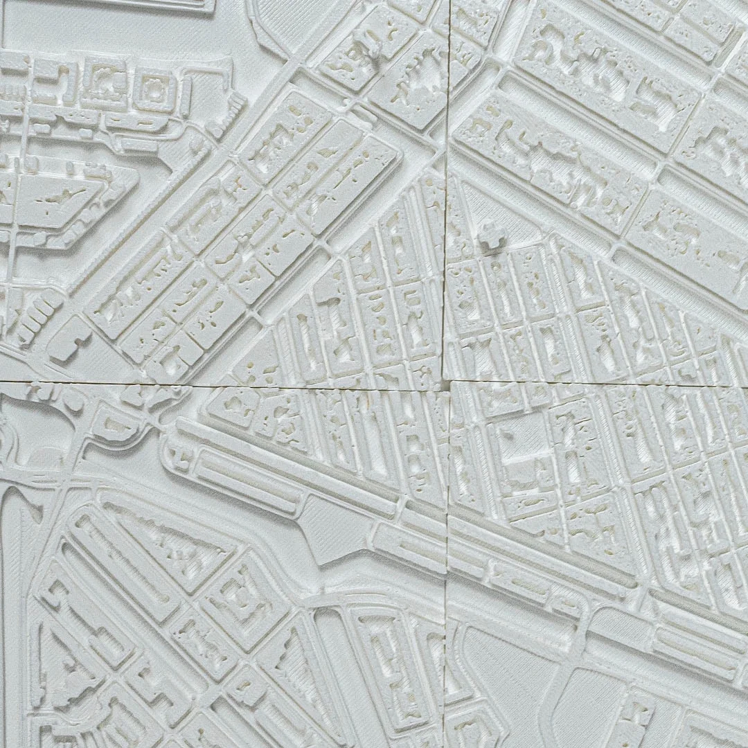 Angled detail of an Amsterdam city relief map showing streets and building heights.
