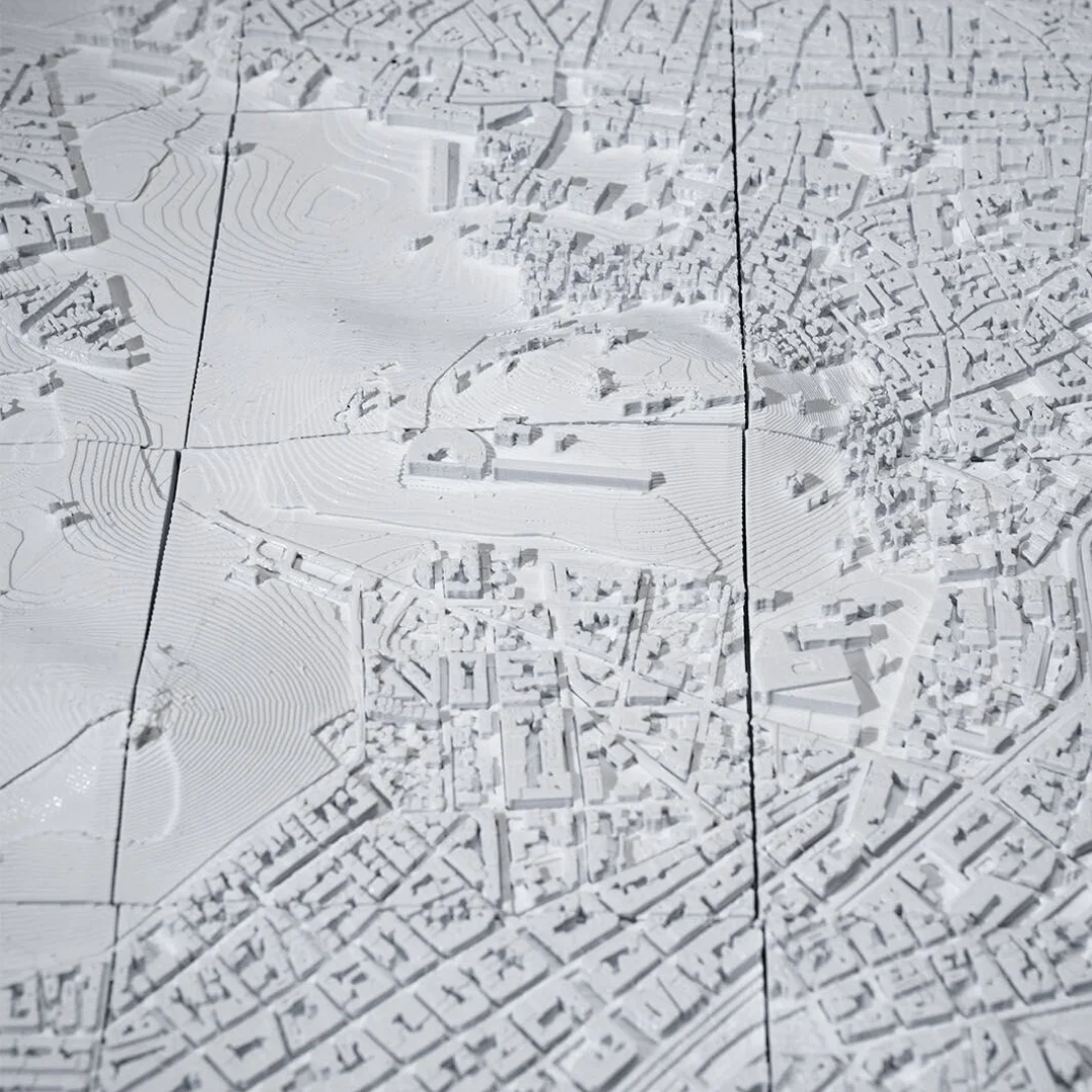 Close overhead view of raised terrain and surrounding buildings in an Athens relief map.