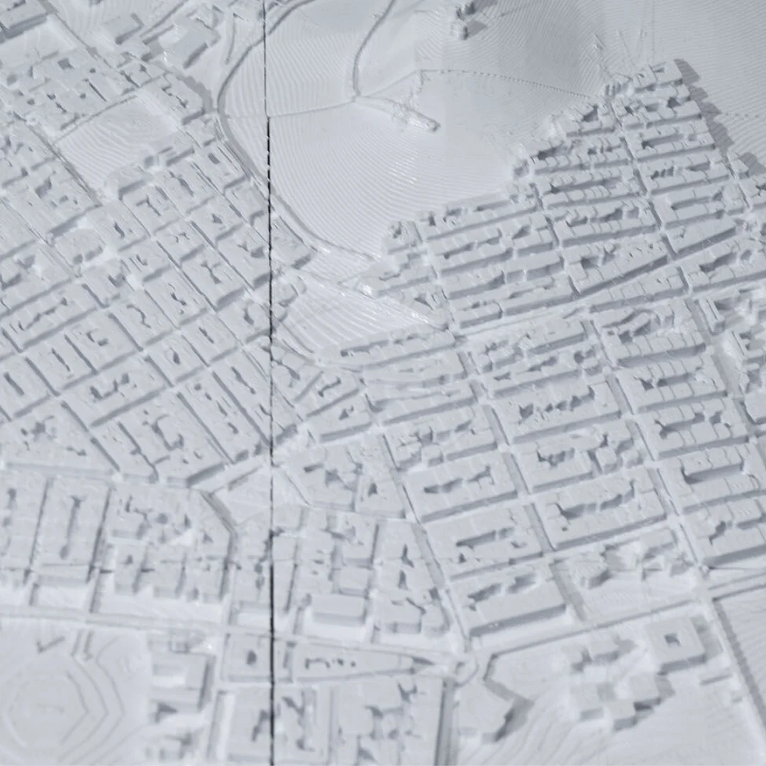 Close view of street blocks beside raised terrain in an Athens relief map.