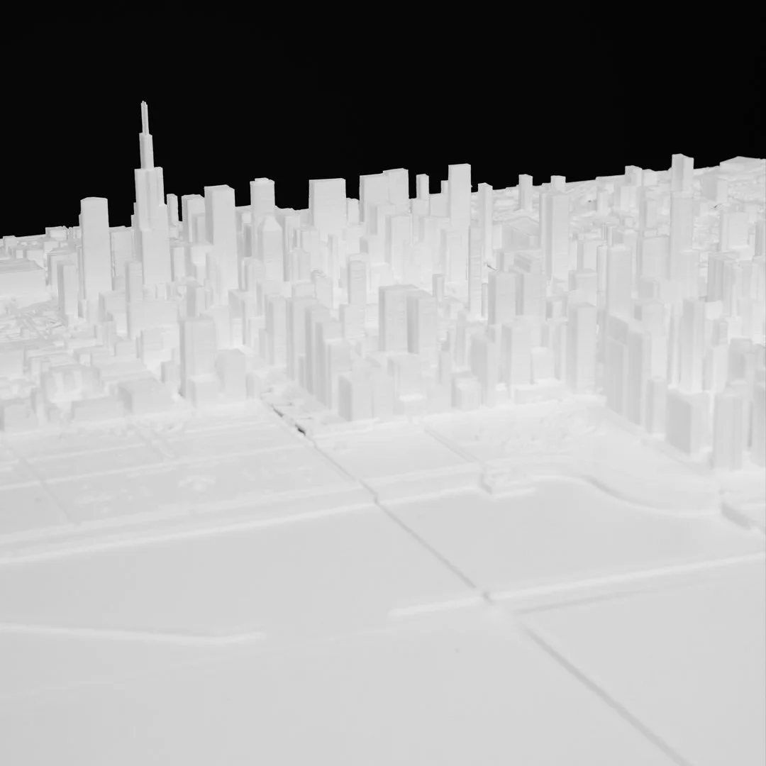 Low view across a Chicago city relief map showing its skyline.