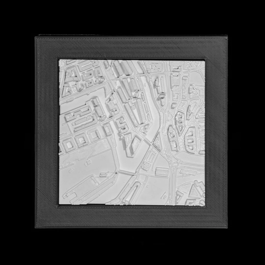 Framed Hamburg city relief map showing streets and waterways.