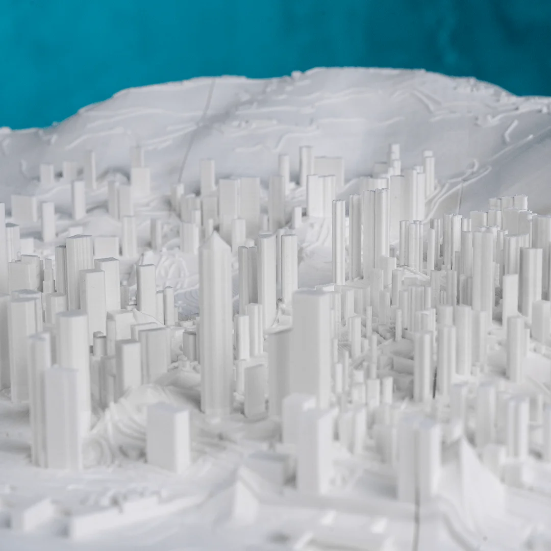 Close view of raised towers and hills in a Hong Kong city relief map.