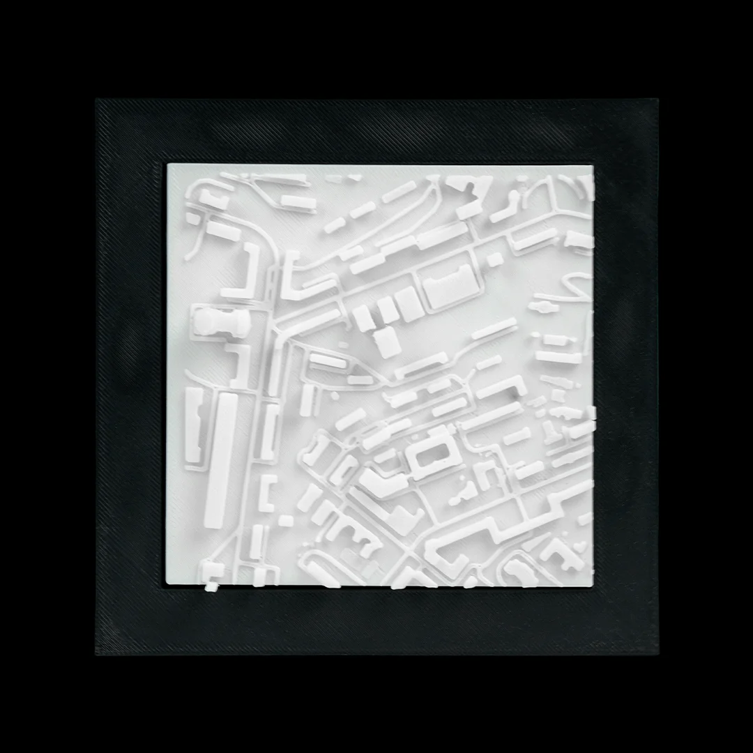 Framed Kyiv city relief map showing buildings and streets.