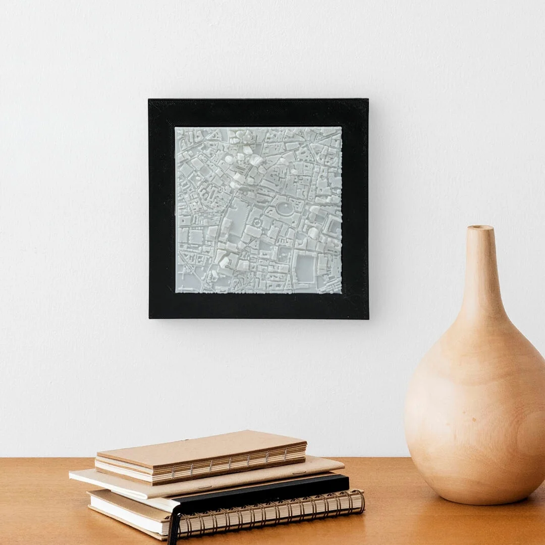 Framed London city relief map displayed on a wall.