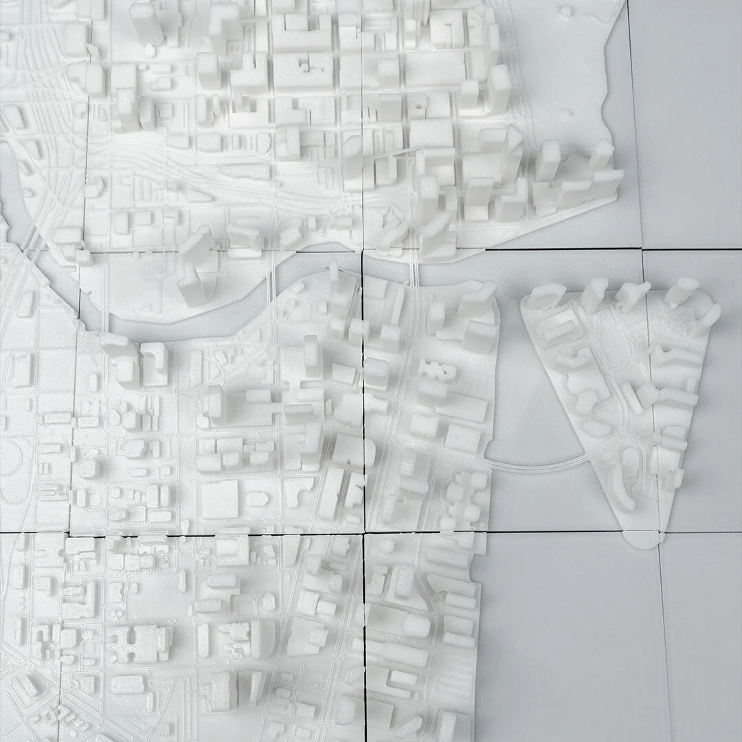 Overhead detail of a Miami relief map showing the waterfront and street grid.
