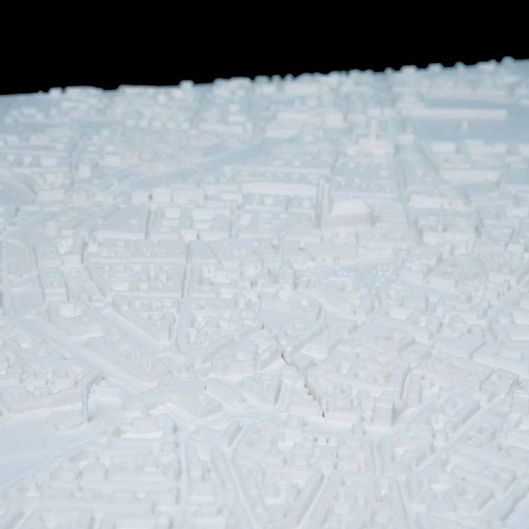 Low wide view of a Munich city relief map showing raised buildings.