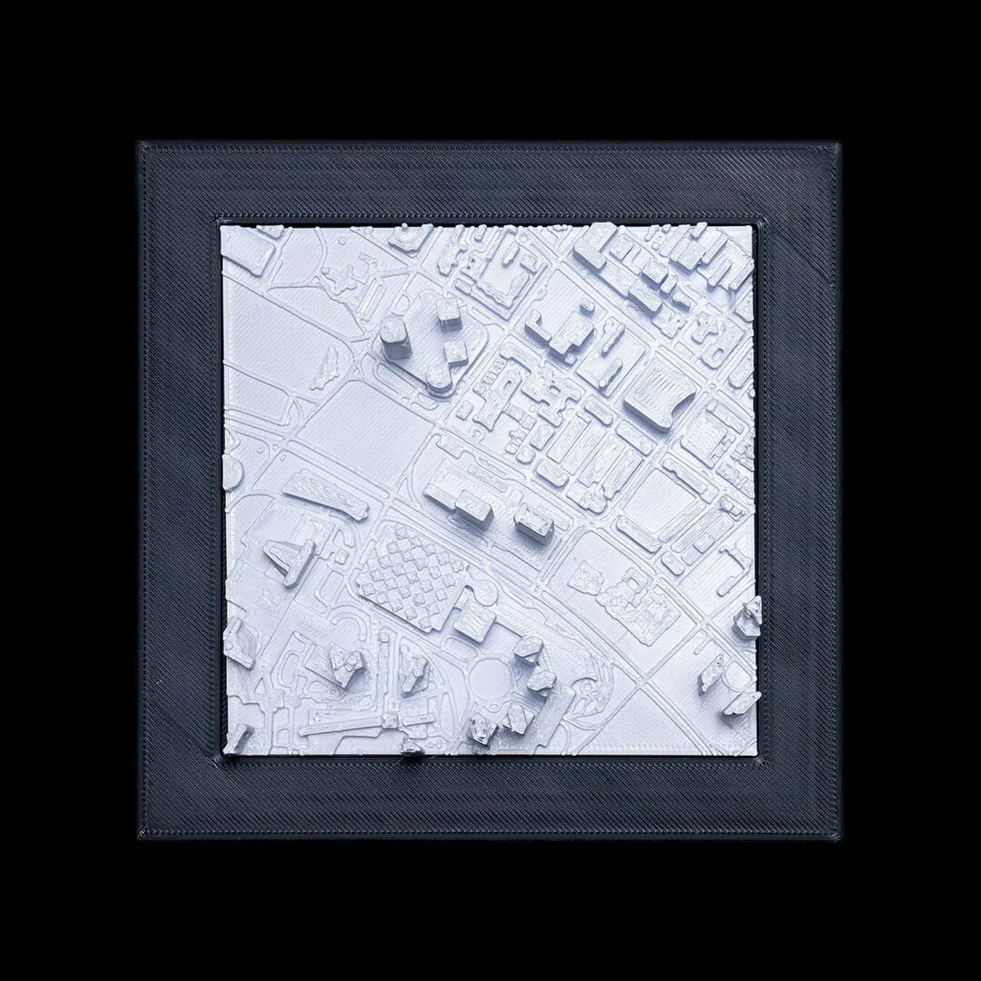 Framed Singapore city relief map showing raised buildings.