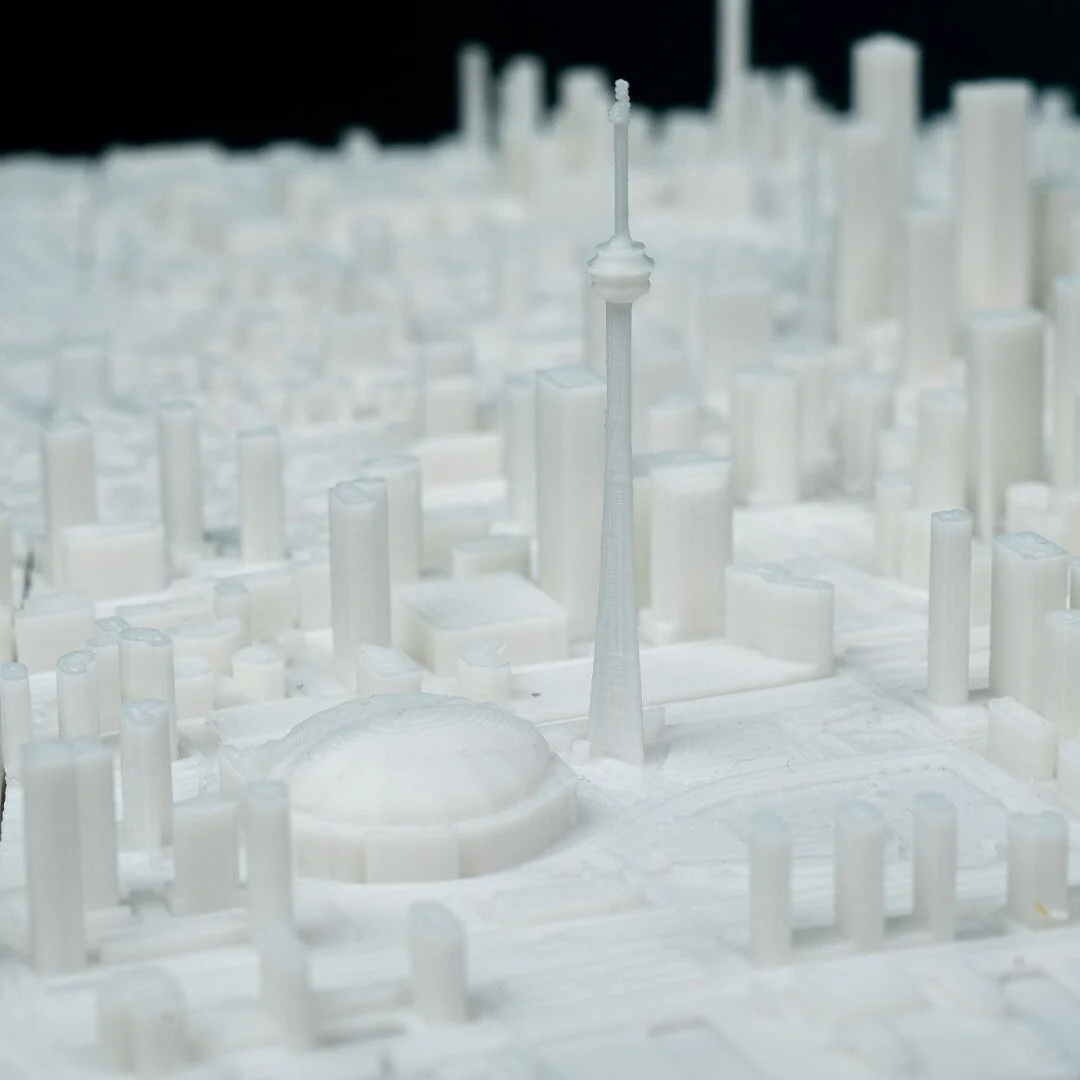Close view of the CN Tower and domed stadium in a Toronto city relief map.