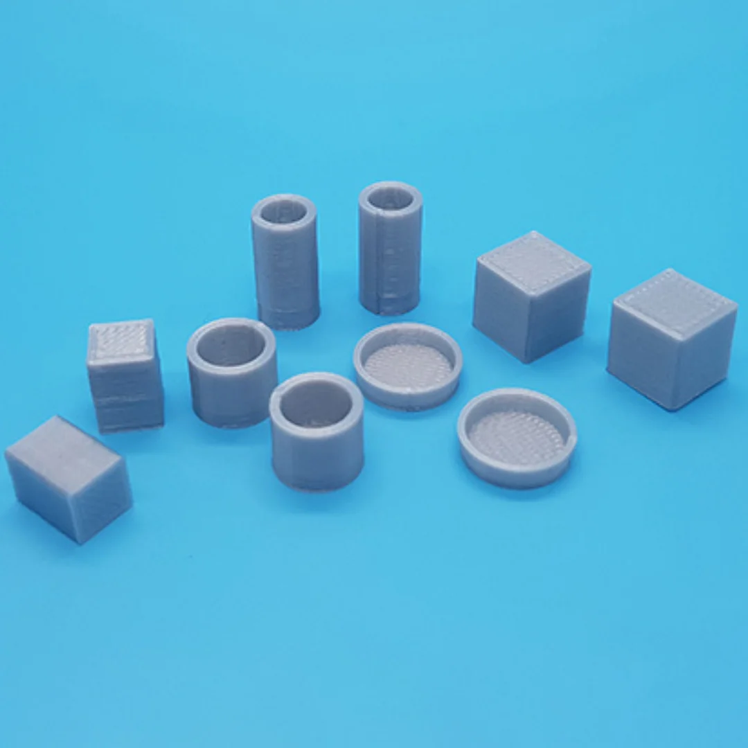 Miniature vases and boxes at 1:20 scale arranged to show their different shapes.