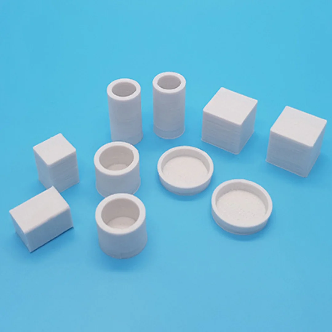 Miniature vases and boxes at 1:20 scale arranged to show their different shapes.