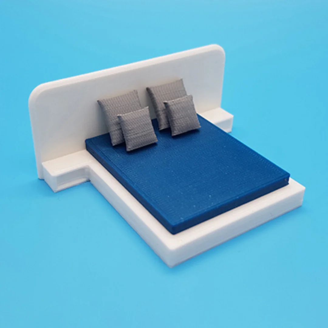 Miniature cushions at 1:50 scale shown on model furniture.
