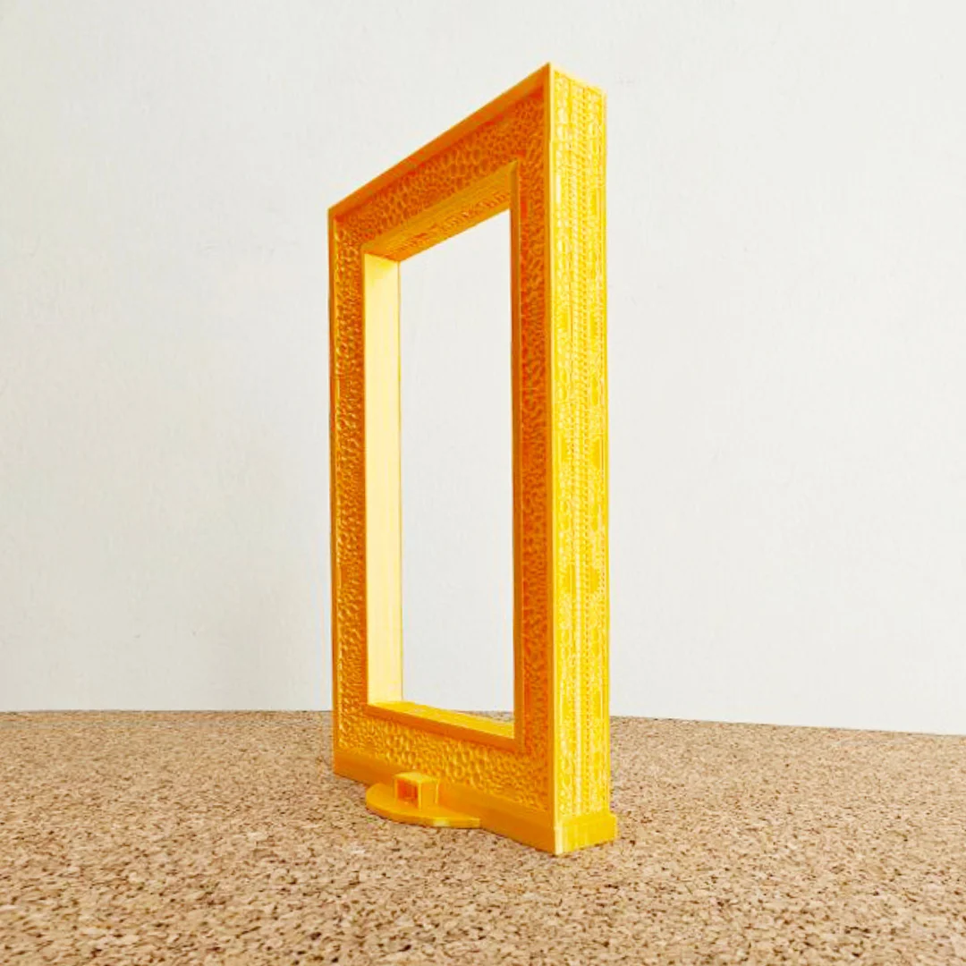 Side angled view of a Dubai Frame model showing the depth of its pillars.