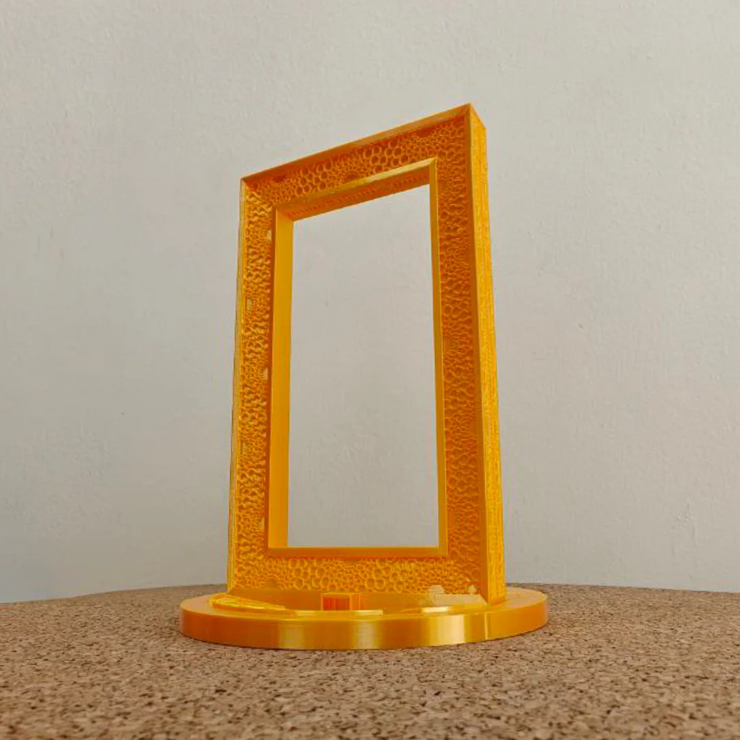 Angled view of a Dubai Frame model on a circular stepped base.