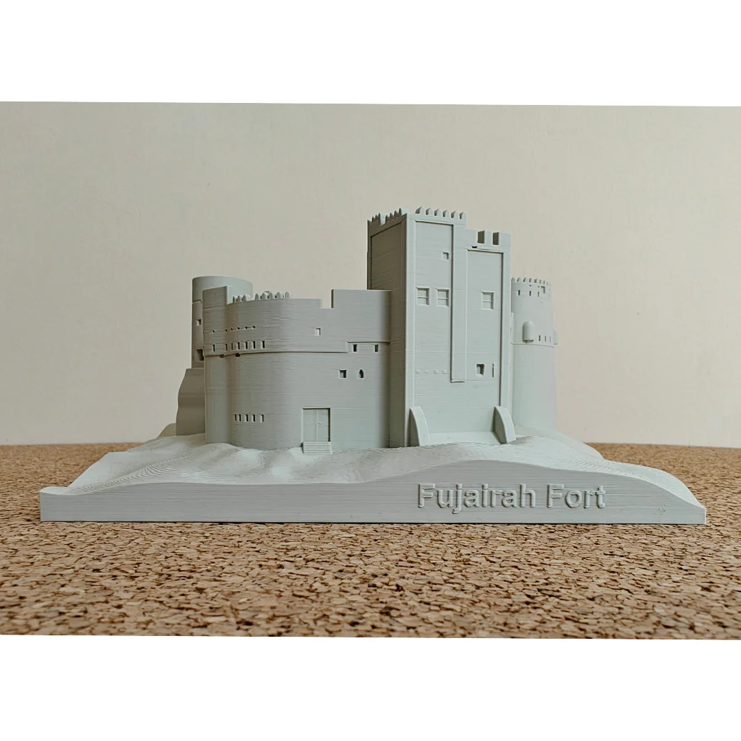 Front view of a Fujairah Fort model with the landmark name on its landscape base.