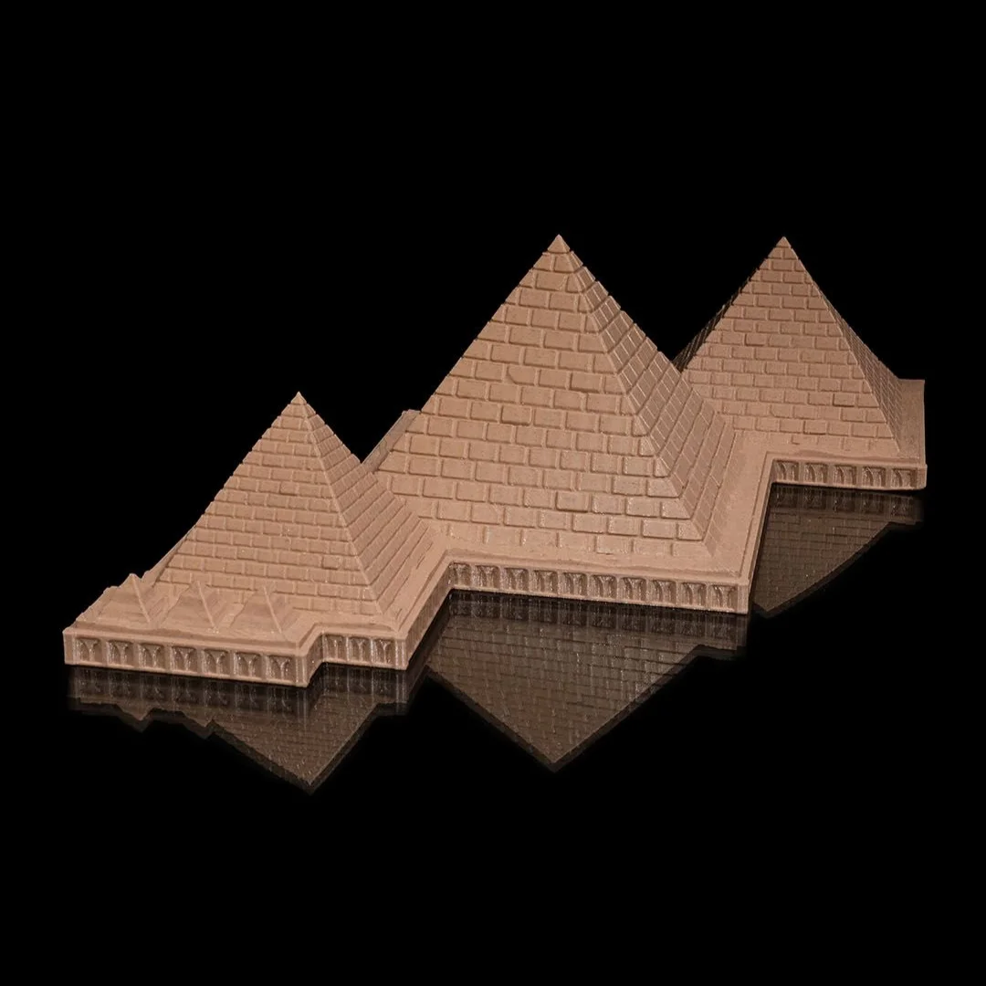 Low angled view of a Giza pyramid complex model showing the stepped base.
