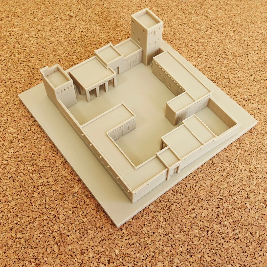 Elevated view of a Khorfakkan Fort model showing its courtyard and square towers.