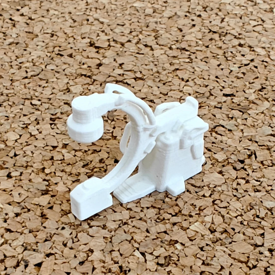 Miniature C-arm X-ray machine model at 1:50 scale.
