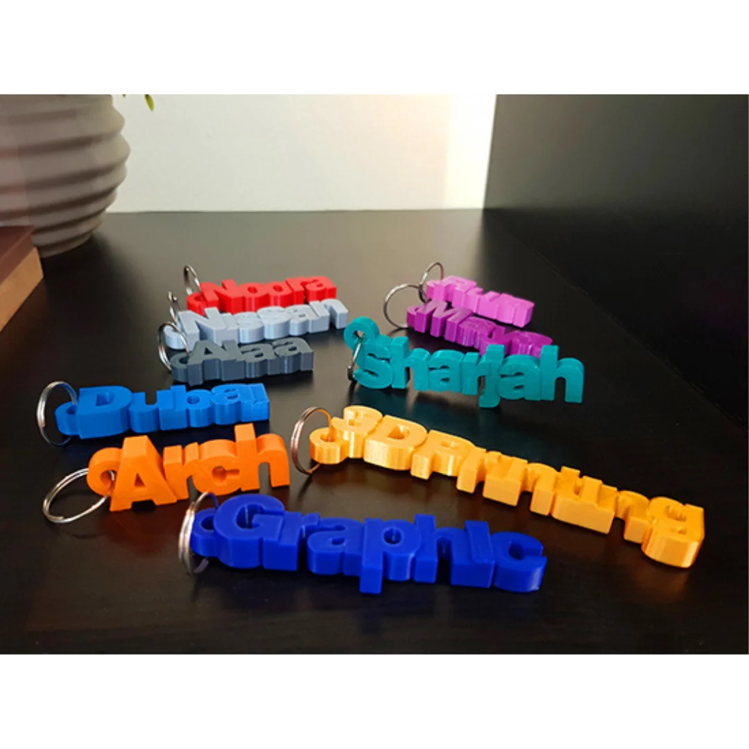 Angled group view of personalised name keychains showing raised letter shapes.