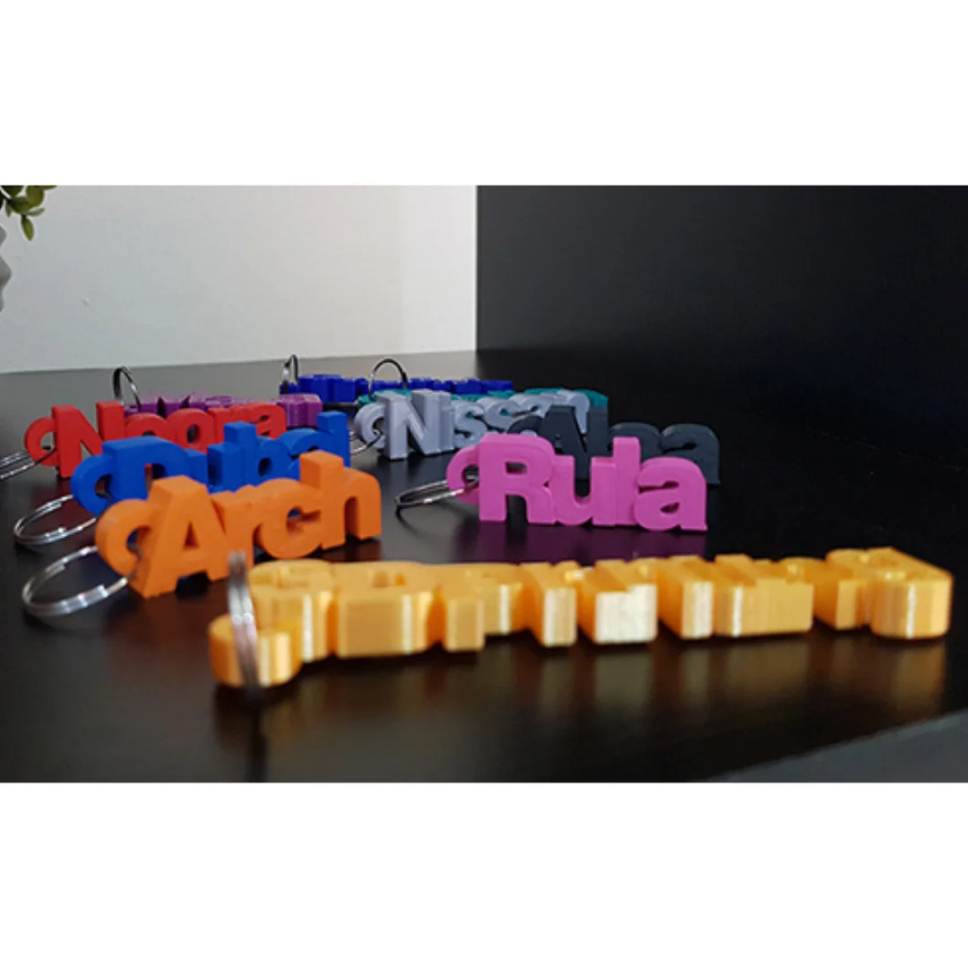 Low side view of personalised name keychains showing the thickness of the letters.