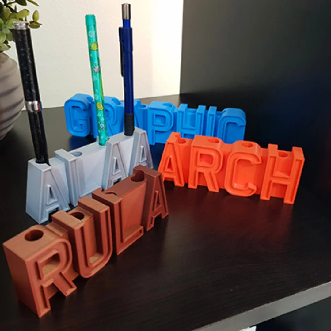Angled view of personalised name pen holders with integrated pen openings.