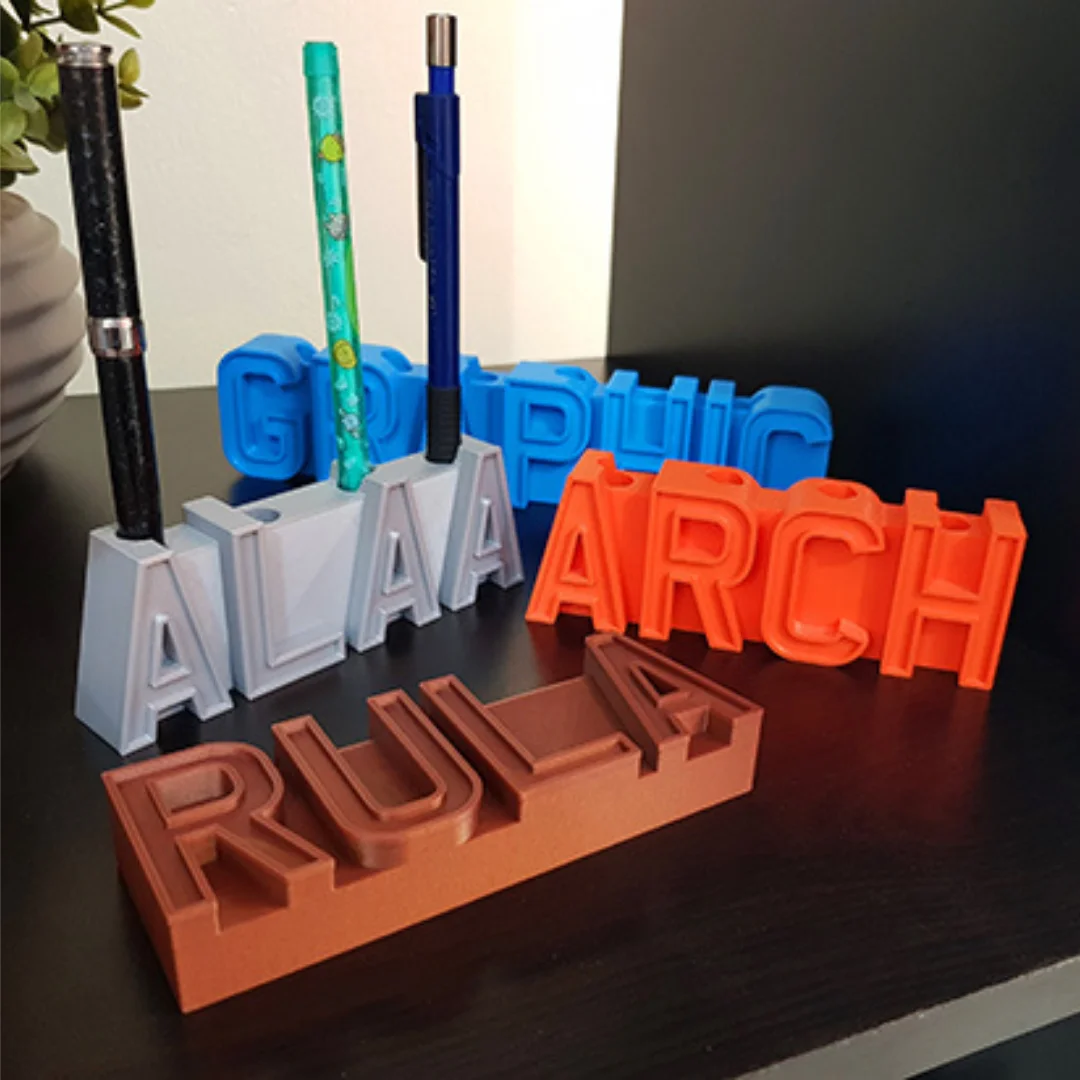 Group view of personalised name pen holders showing freestanding letters and pens.