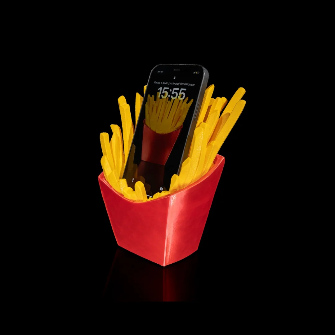 French fries carton phone holder supporting a smartphone at an angle.