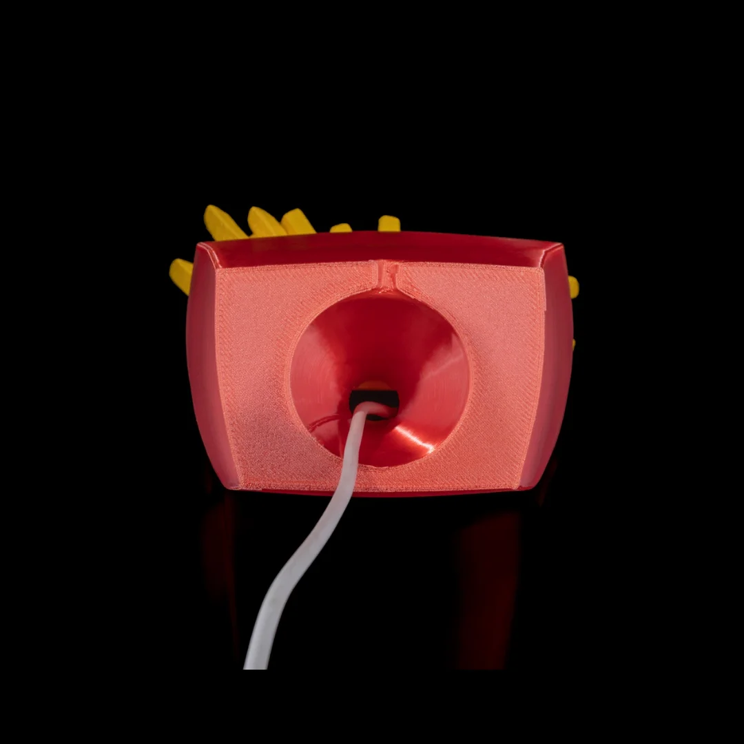 Underside of a French fries phone holder showing a cable opening.