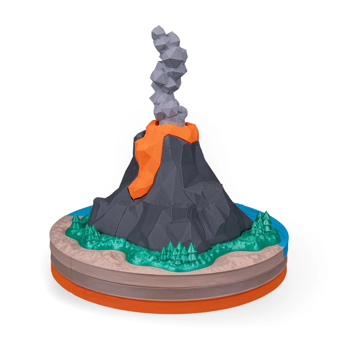 Volcano teaching model with lava flow and a smoke plume on a layered base.
