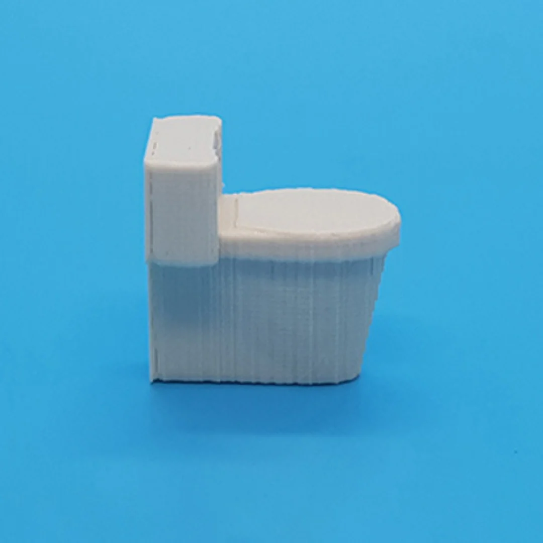 Miniature toilet model at 1:50 scale.