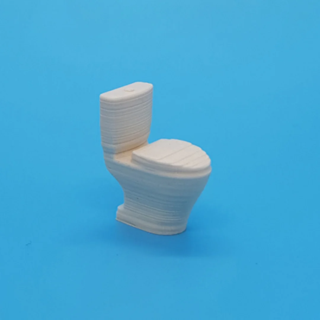 Miniature toilet model at 1:50 scale.