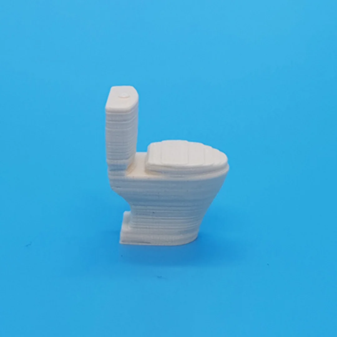 Miniature toilet model at 1:50 scale.