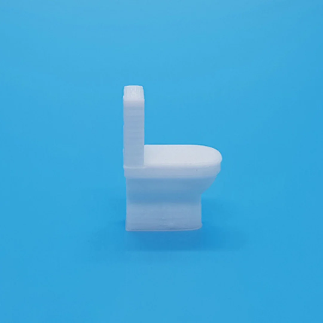 Miniature toilet model at 1:50 scale.