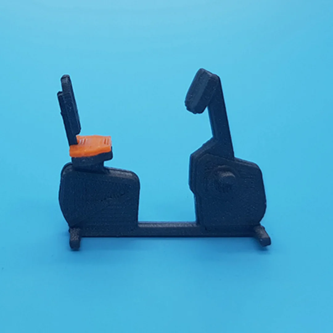 Seated exercise bike miniature model viewed from the side at 1:50 scale.