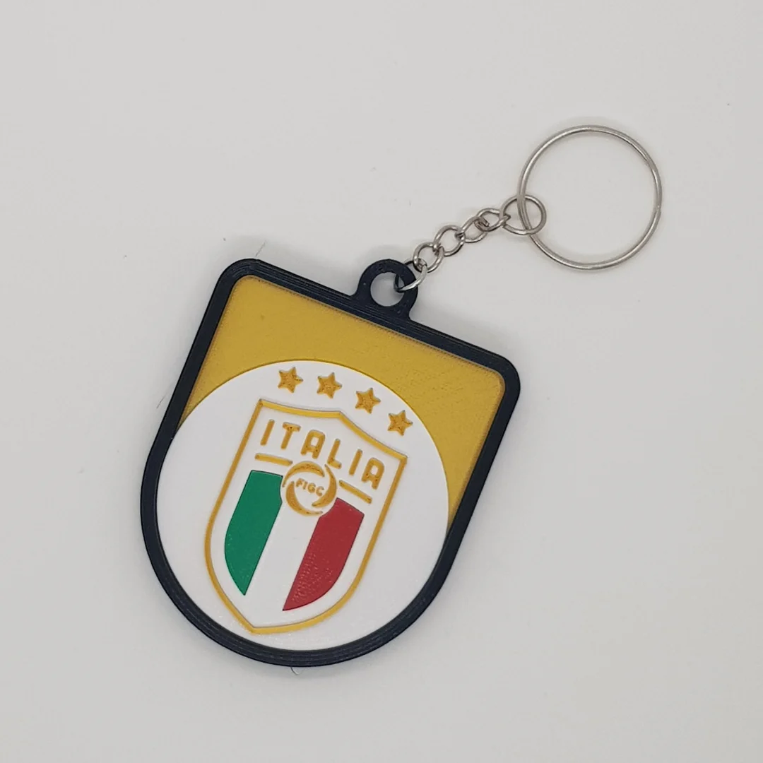 Front view of a Italy football crest keychain with its chain and key ring.
