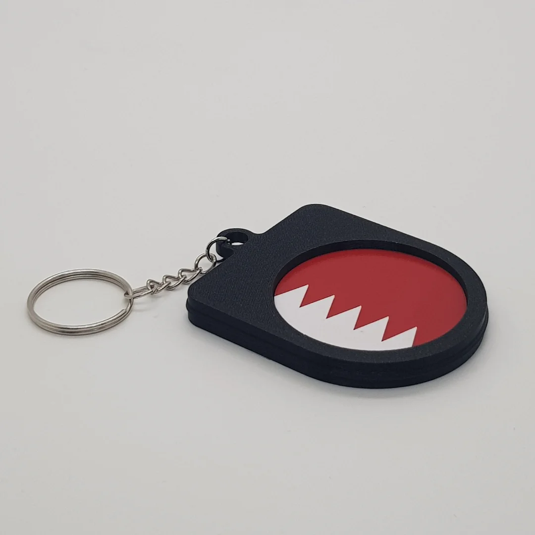 Angled rear view of a Bahrain football keychain showing the national flag inset.