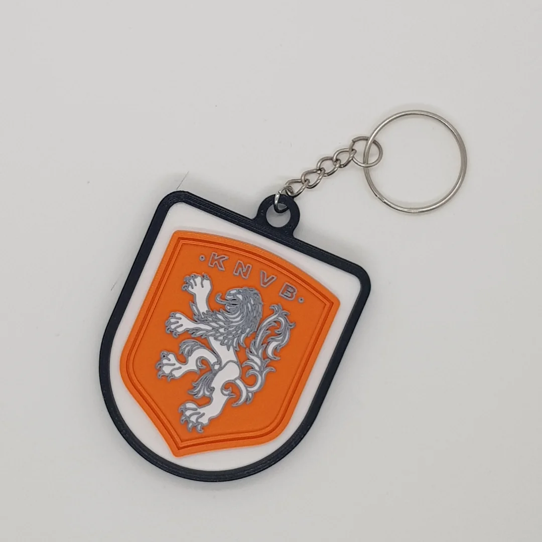 Front view of a Netherlands football crest keychain with its chain and key ring.