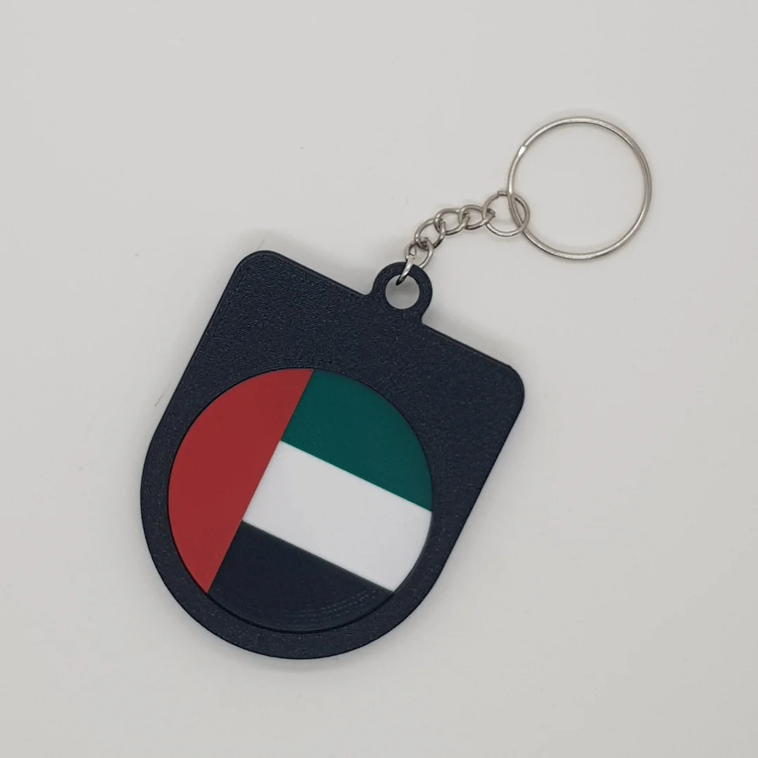 Rear view of a UAE football keychain showing the national flag.