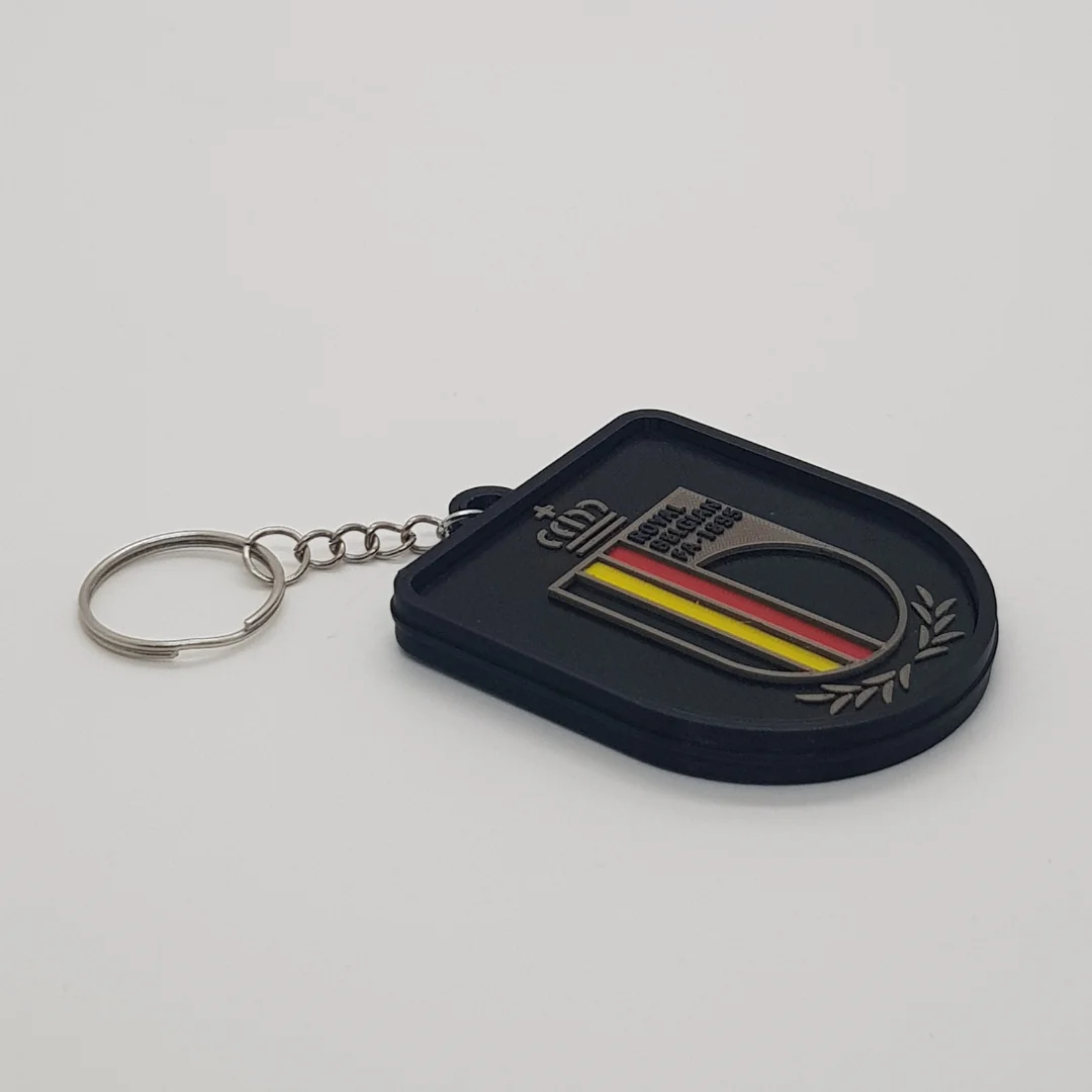Angled front view of the Belgium football keychain showing its crest and metal key ring.