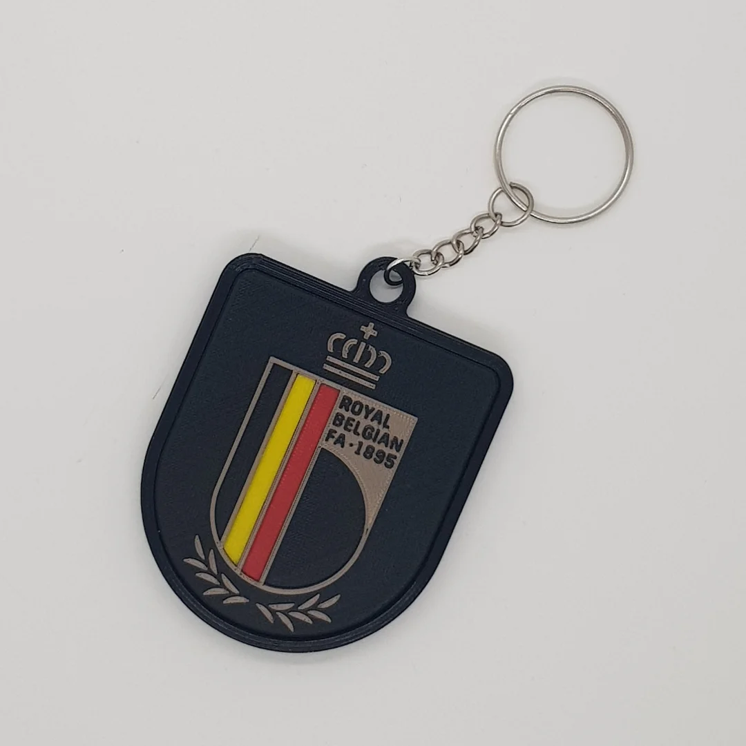 Front view of the Belgium football crest keychain with its chain and key ring.