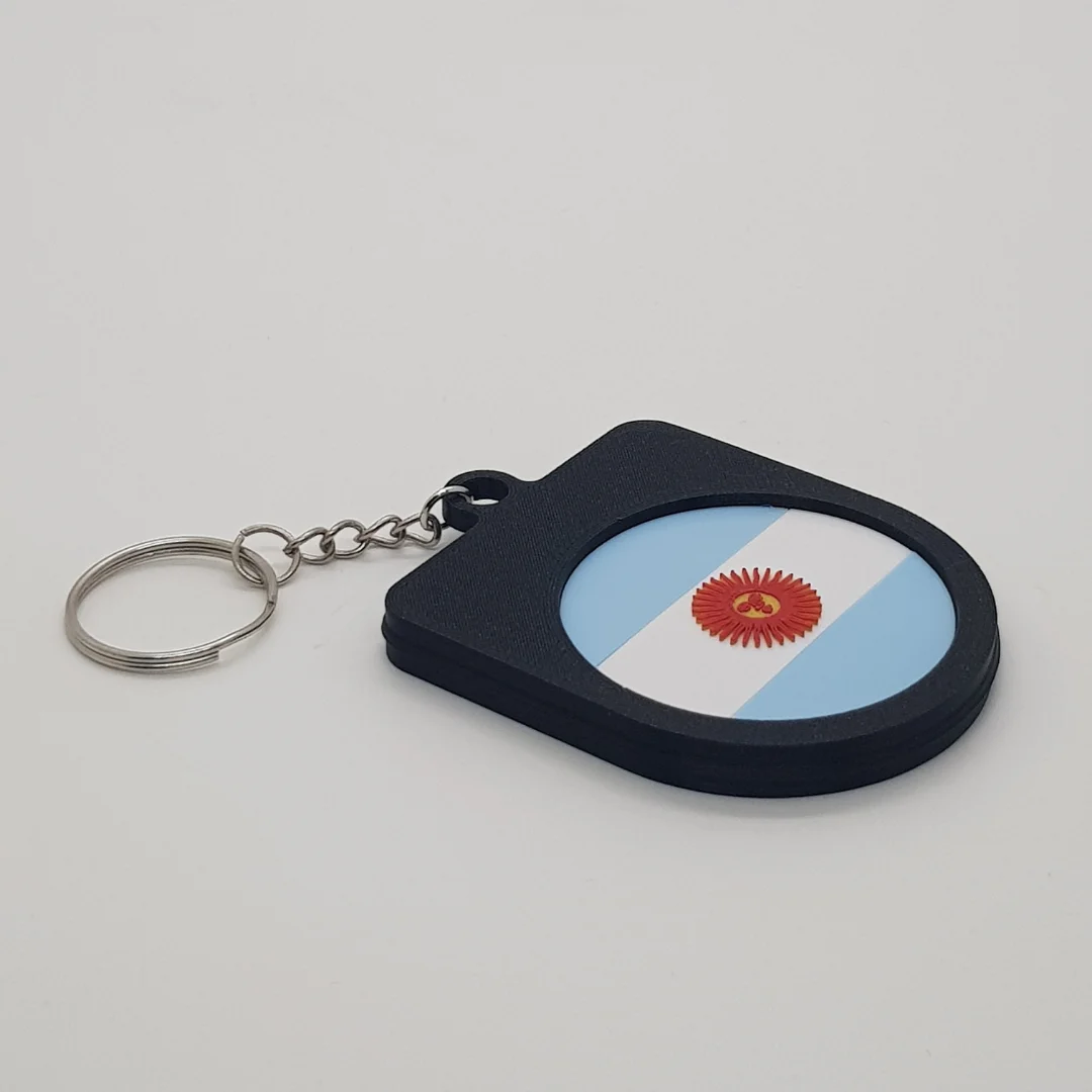 Angled rear view of the Argentina football keychain showing the national flag inset.