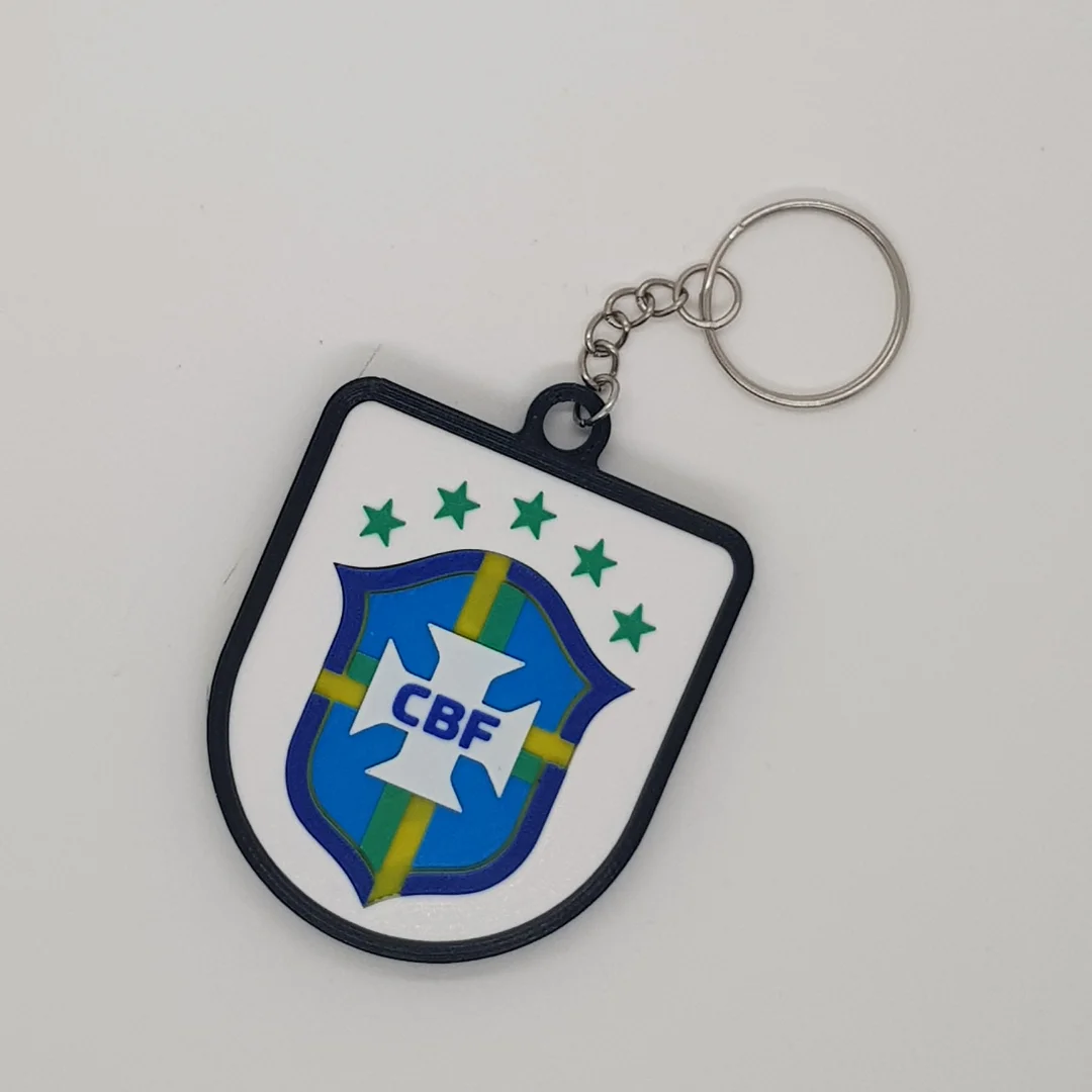 Front view of the Brazil football crest keychain with its chain and key ring.