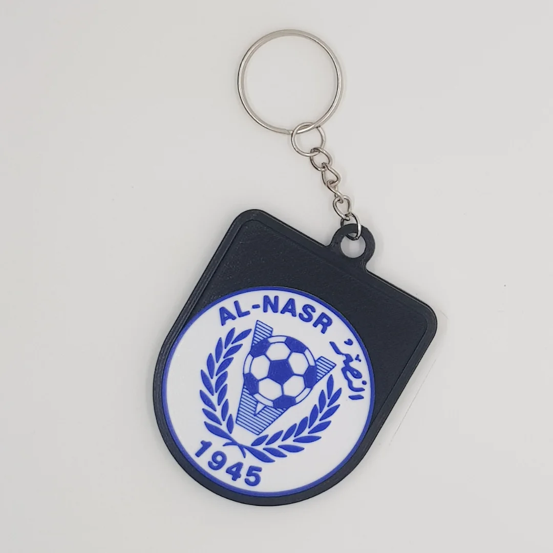 Front view of the Al-Nasr Emirates crest keychain with its chain and metal ring.