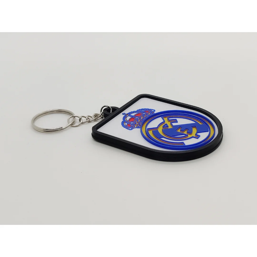 Angled view of the Real Madrid CF keychain showing its raised club crest and key ring.