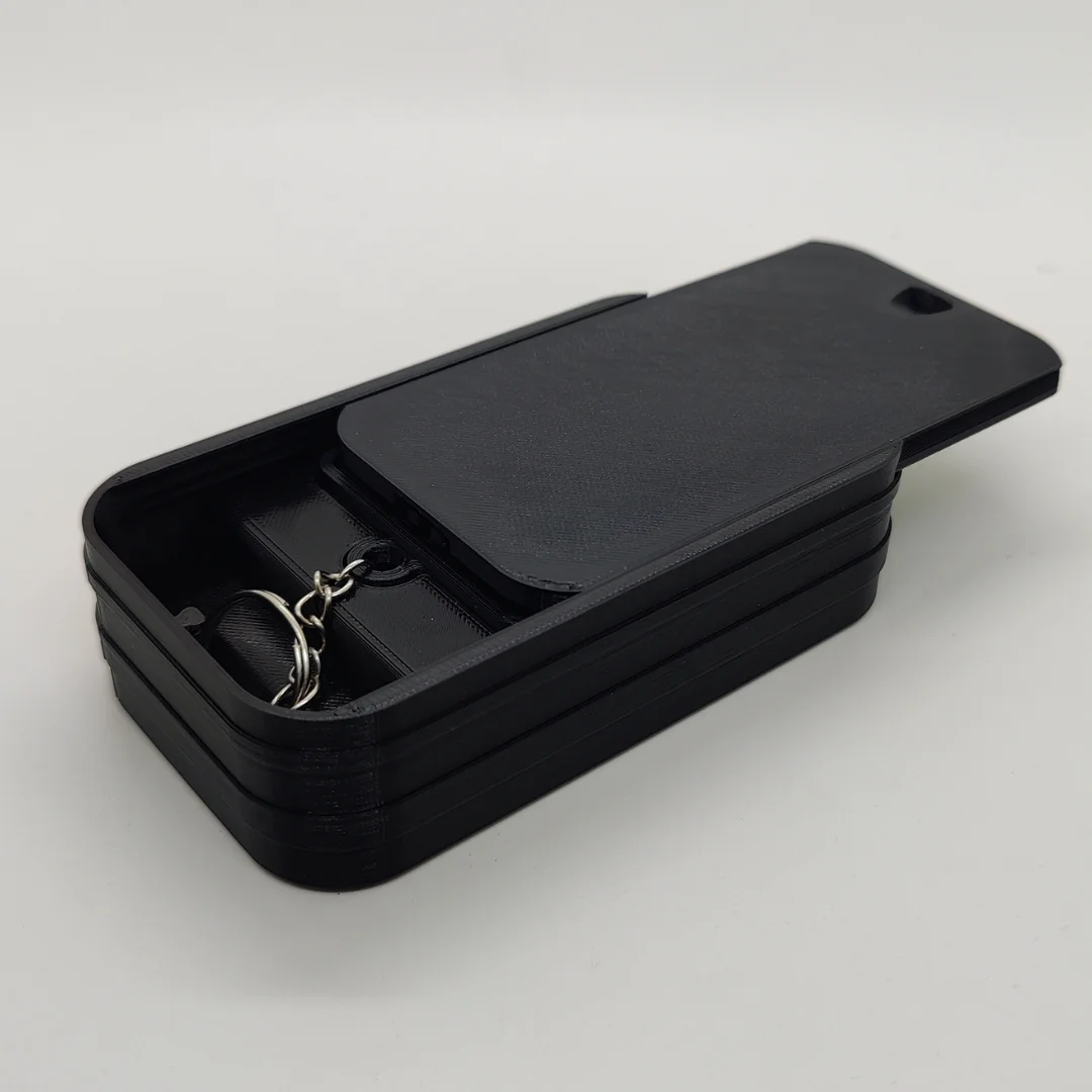 Presentation box for the Al Dhafra FC keychain with its sliding lid partly closed.