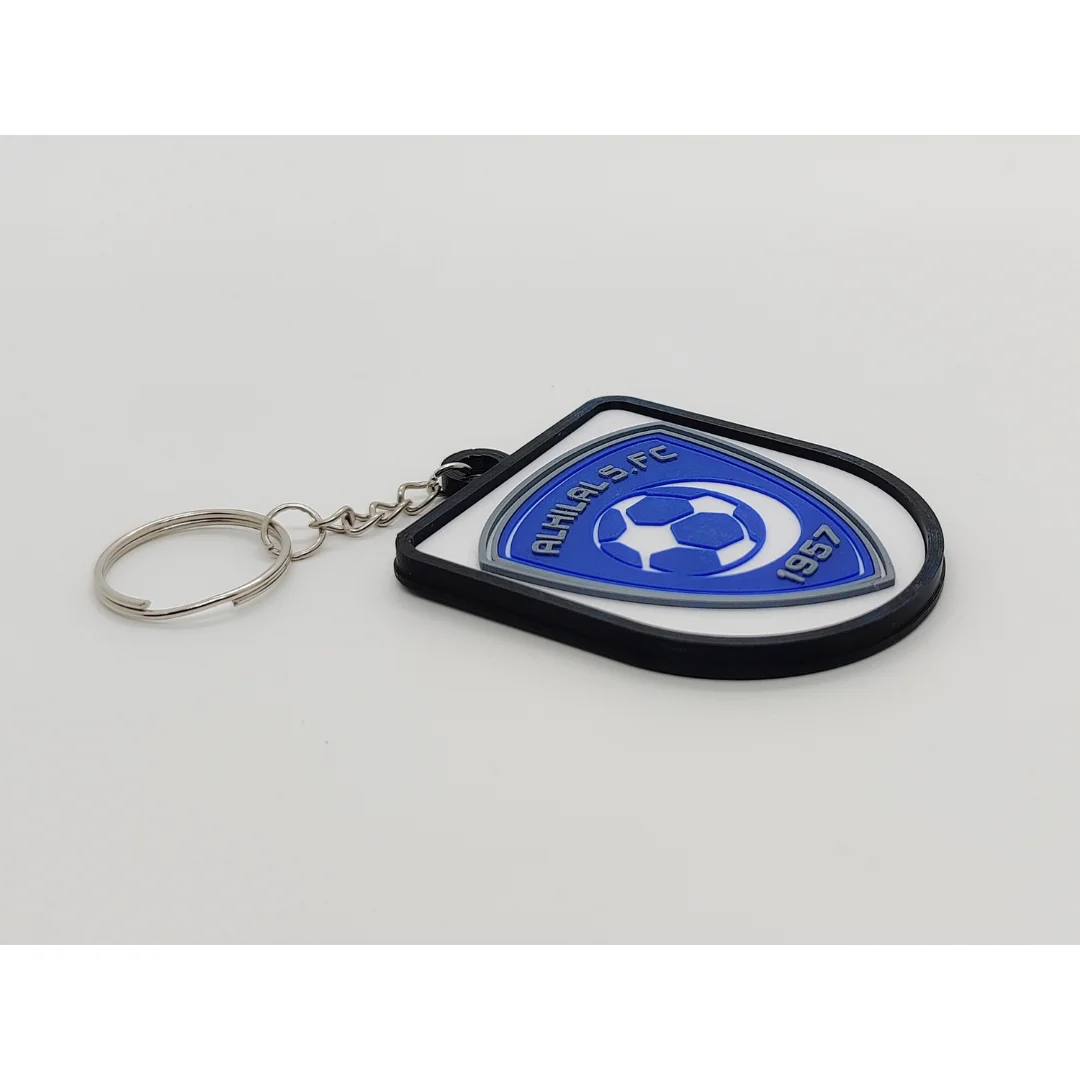 Angled view of the Al-Hilal Saudi FC keychain showing the club crest and metal key ring.