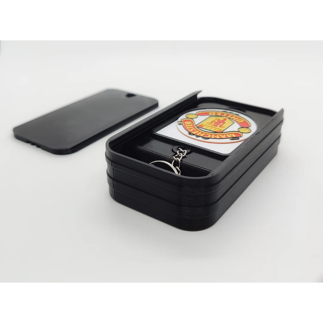 Manchester United FC keychain displayed inside an open presentation box.