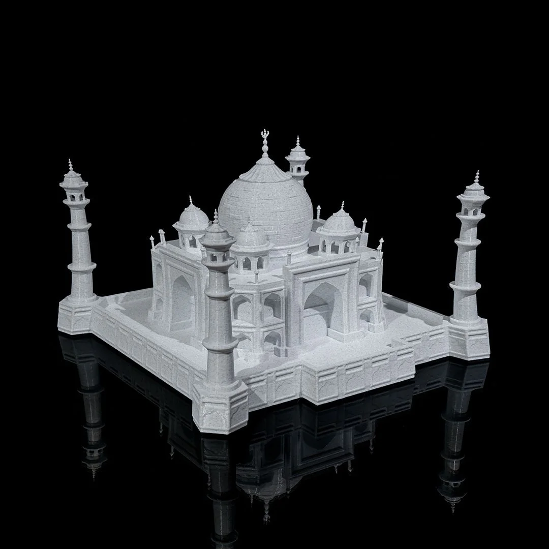 Angled view of a Taj Mahal model showing arched facades and corner minarets.