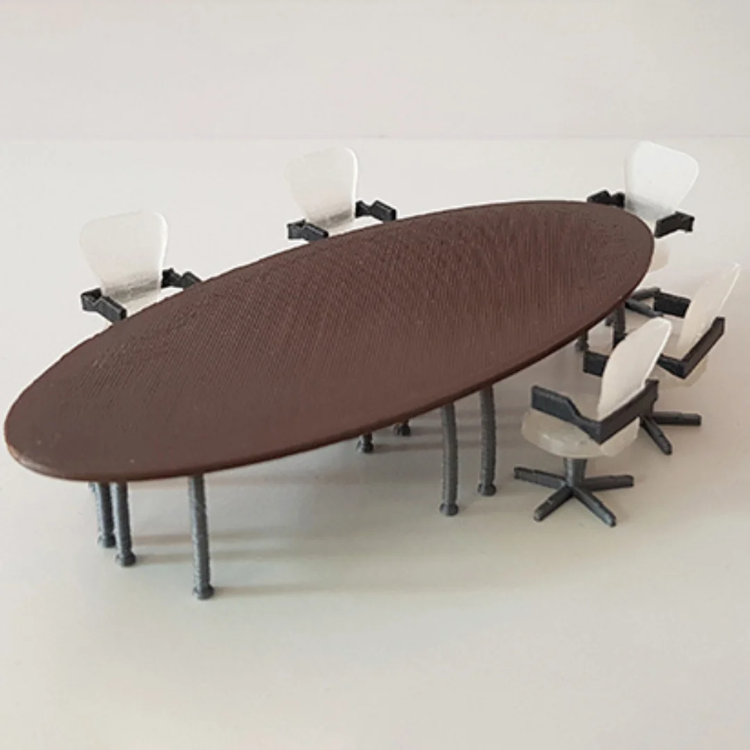 Oval meeting table miniature model at 1:50 scale shown with miniature office chairs.