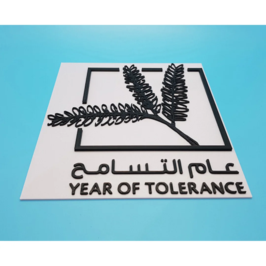 Low angled view of a Year of Tolerance plaque showing its raised logo and lettering.